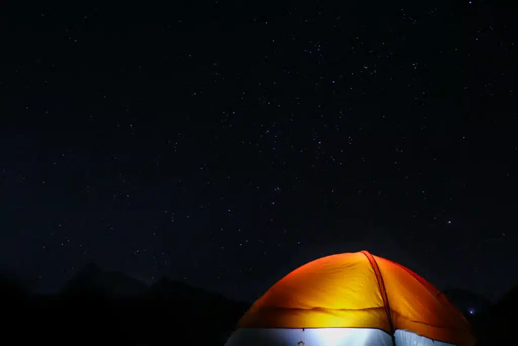 Rechargeable camping lantern illuminating tent interior at night