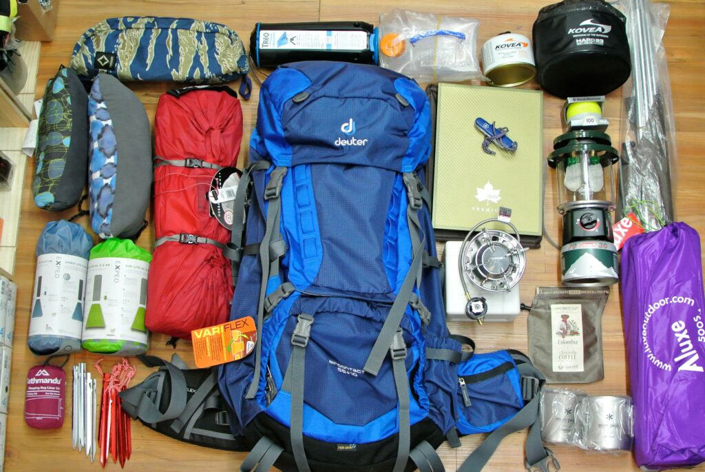 Backpacker demonstrating proper packing technique in outdoor setting